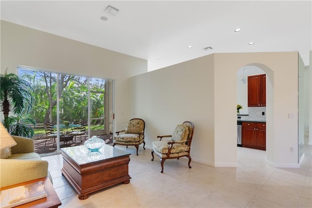 9520 E Maiden Ct, Vero Beach, FL 32963 - living area with arched walkways, recessed lighting, light tile patterned floors, and baseboards
