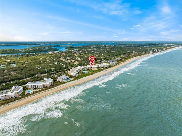 birds eye view of property featuring a water view and a view of the beach