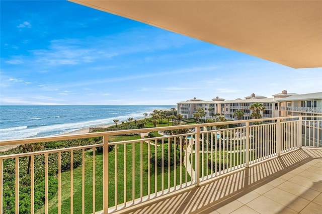 balcony featuring a water view and a view of the beach