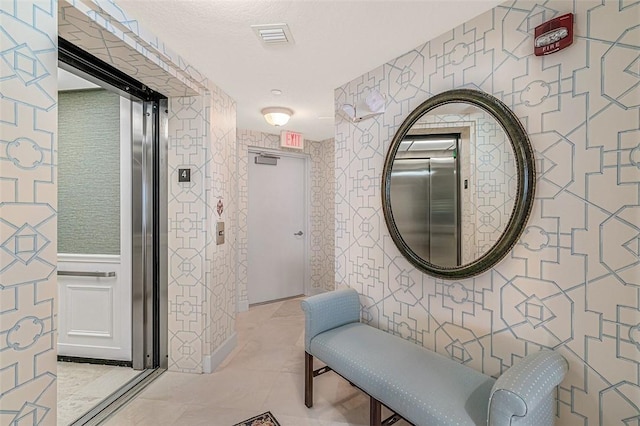 hall featuring light tile patterned flooring