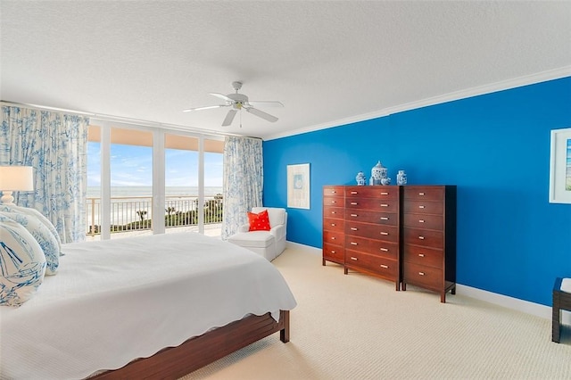 carpeted bedroom featuring crown molding, ceiling fan, access to exterior, and a textured ceiling