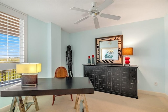 carpeted home office featuring ceiling fan