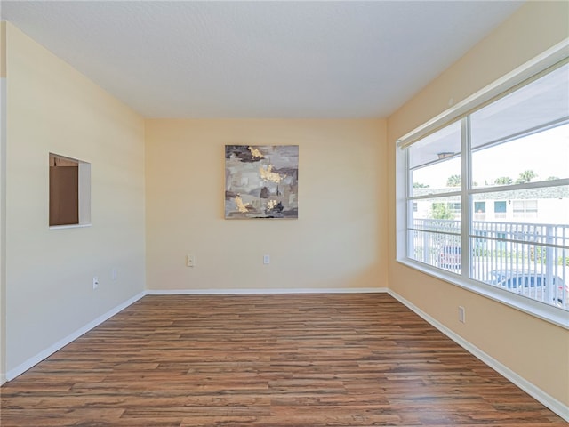 empty room with dark hardwood / wood-style flooring