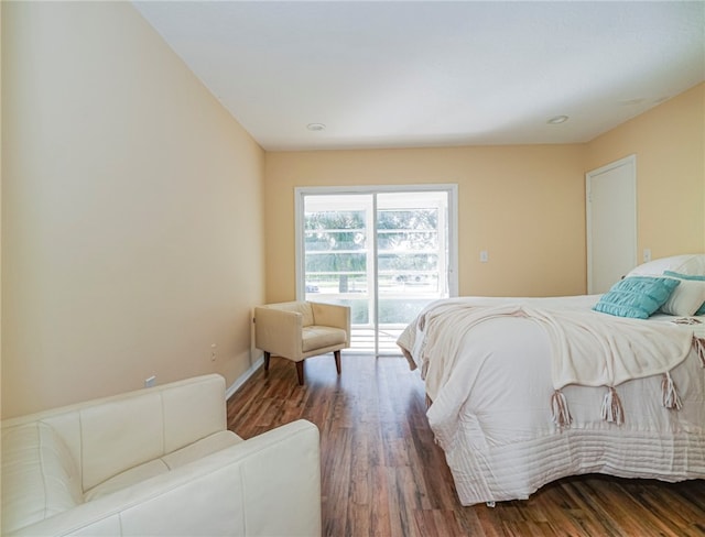 bedroom featuring access to exterior and dark hardwood / wood-style flooring