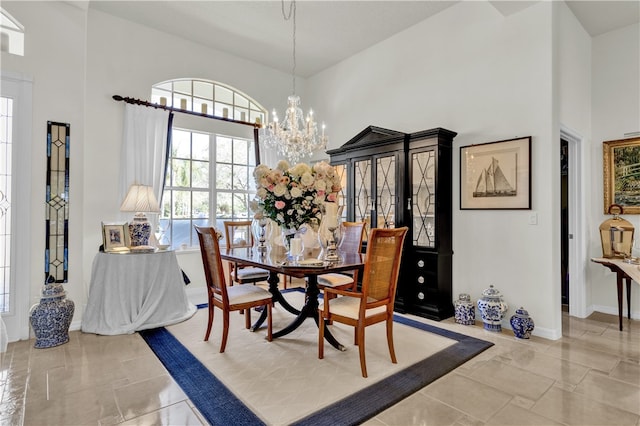 dining room with a high ceiling and an inviting chandelier