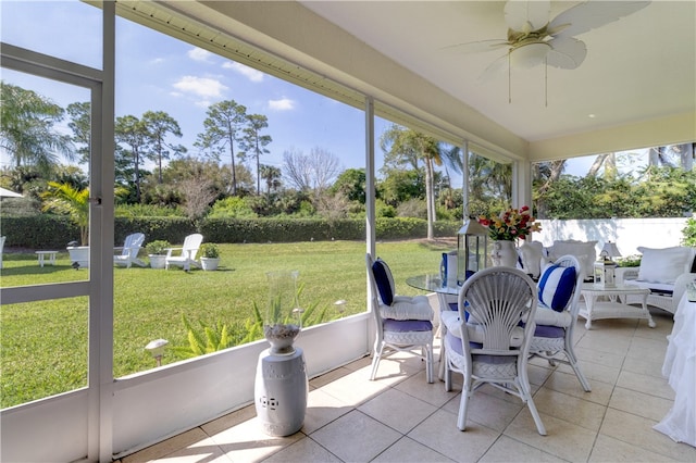 sunroom / solarium featuring ceiling fan