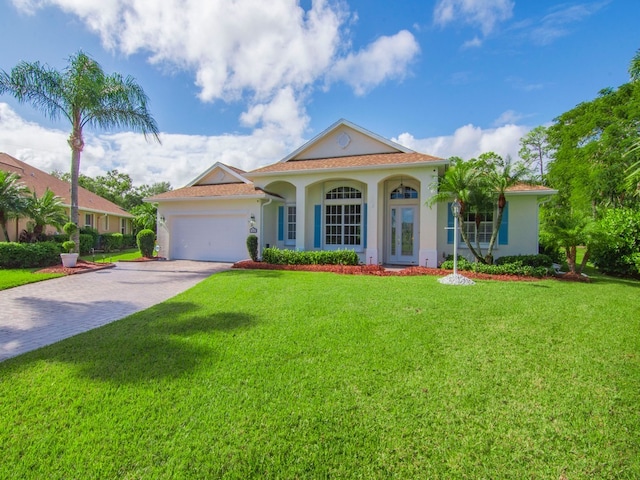 mediterranean / spanish house with a garage and a front yard