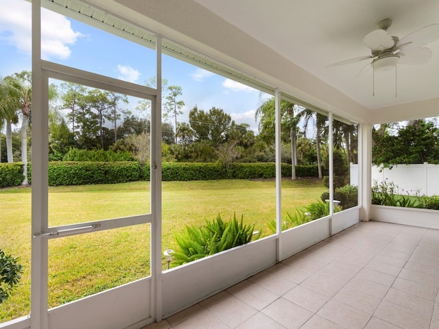 unfurnished sunroom featuring a wealth of natural light and ceiling fan