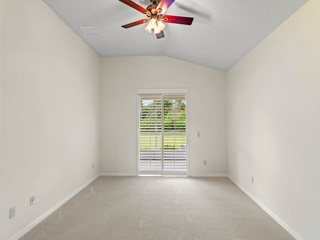 carpeted empty room featuring ceiling fan and lofted ceiling