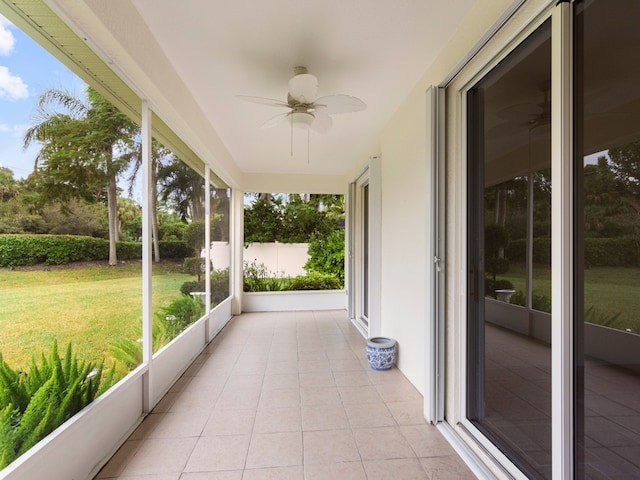 unfurnished sunroom featuring ceiling fan