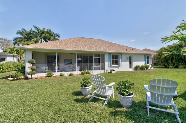 back of house featuring a sunroom and a yard