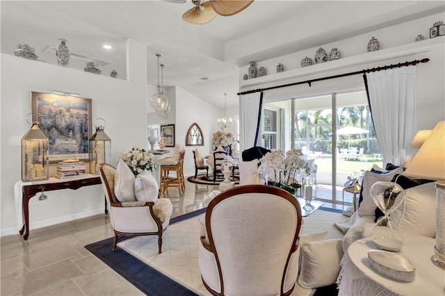 living room with ceiling fan with notable chandelier