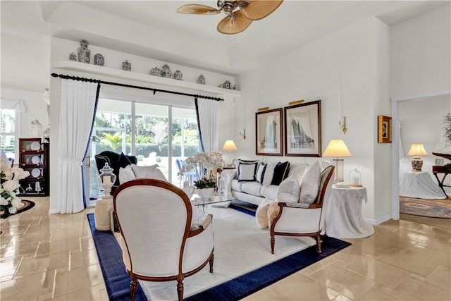 living room with a healthy amount of sunlight and ceiling fan