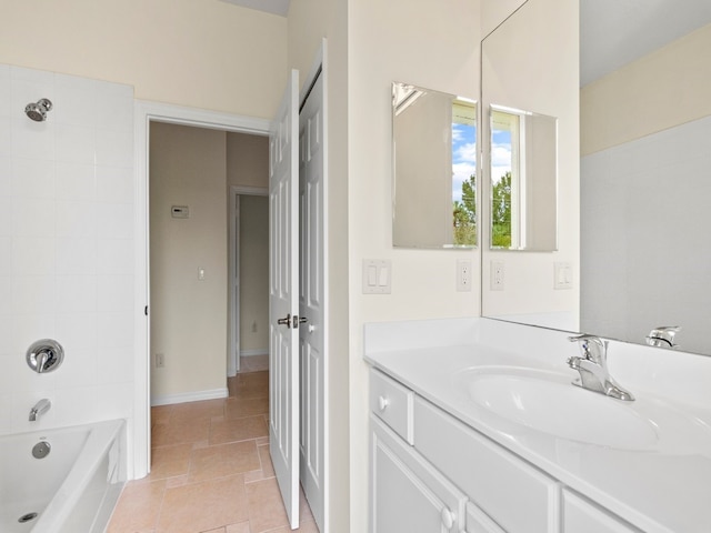 bathroom featuring vanity and tiled shower / bath