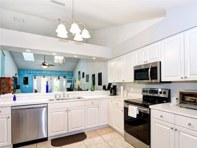 kitchen featuring white cabinetry, lofted ceiling, sink, and stainless steel appliances