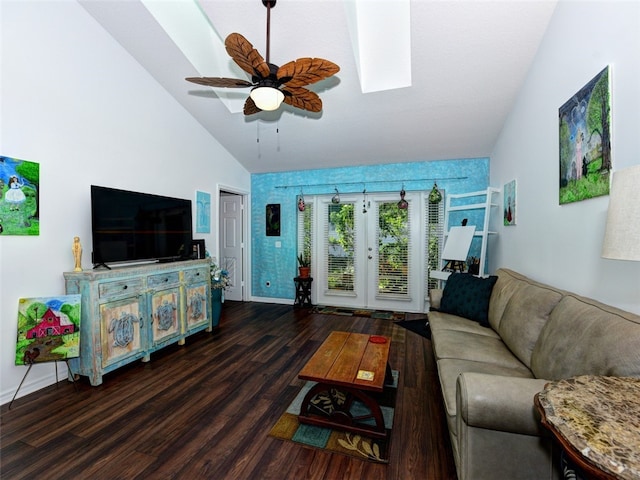 living room featuring dark wood-type flooring, high vaulted ceiling, a skylight, and ceiling fan