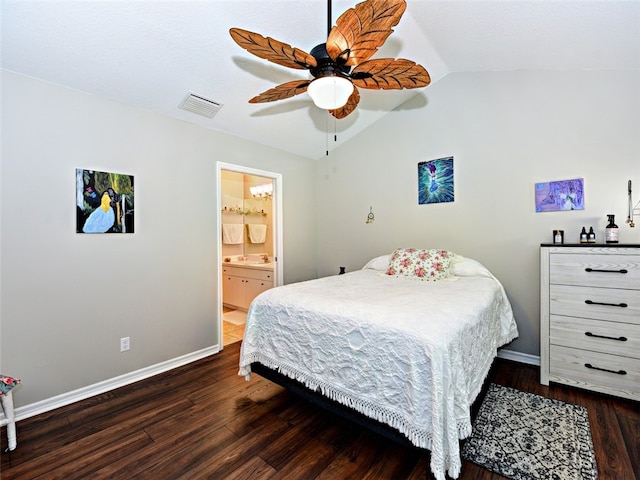 bedroom with ceiling fan, dark hardwood / wood-style floors, vaulted ceiling, and connected bathroom