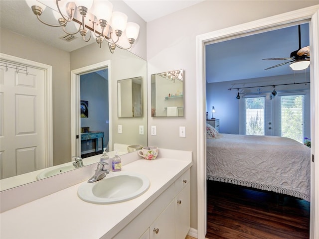 bathroom featuring hardwood / wood-style floors, ceiling fan, vanity, and french doors