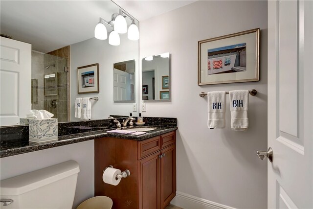 bathroom with vanity, toilet, a notable chandelier, and a shower with shower door