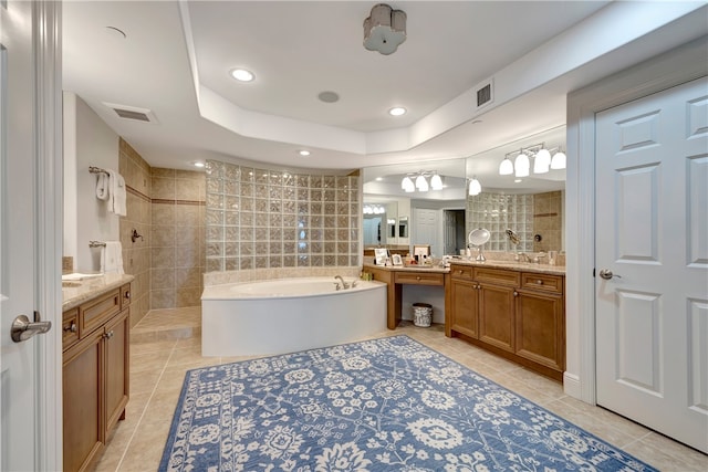 bathroom featuring independent shower and bath, vanity, tile patterned flooring, and a raised ceiling