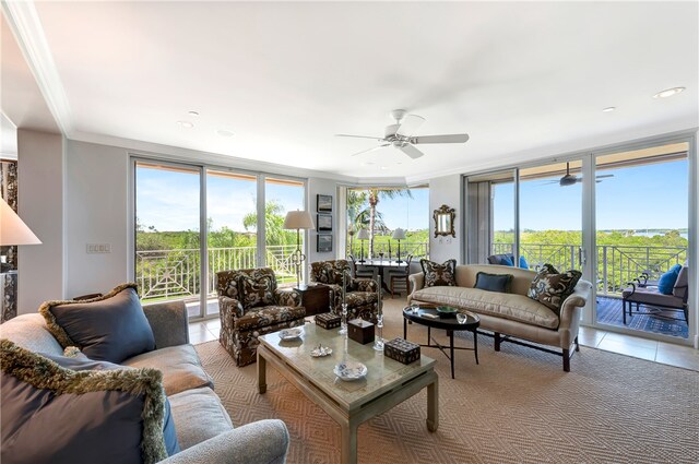 tiled living room featuring expansive windows, ceiling fan, and crown molding