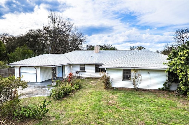 view of front of property with a front yard, fence, roof with shingles, an attached garage, and a chimney