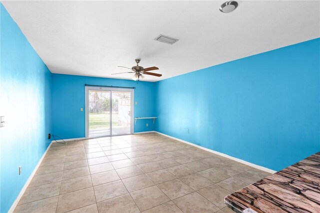 tiled bedroom featuring ceiling fan