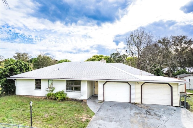 ranch-style home with a garage, concrete driveway, a shingled roof, and a front yard