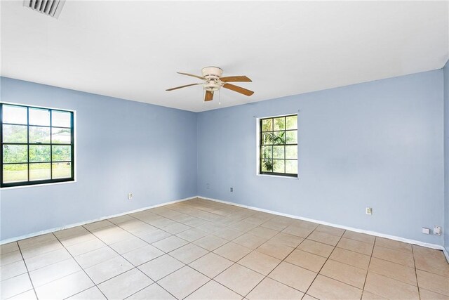 living room with ceiling fan and tile patterned floors