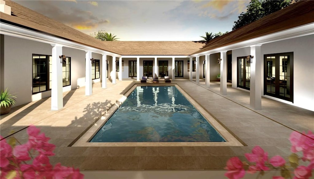 pool at dusk featuring french doors and a patio area