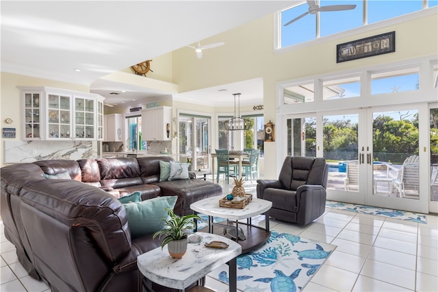 living room featuring ornamental molding, french doors, a high ceiling, and light tile patterned flooring