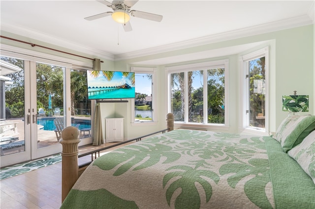 bedroom with french doors, ornamental molding, multiple windows, and access to outside