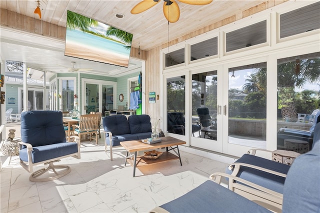 sunroom with wooden ceiling, french doors, and ceiling fan