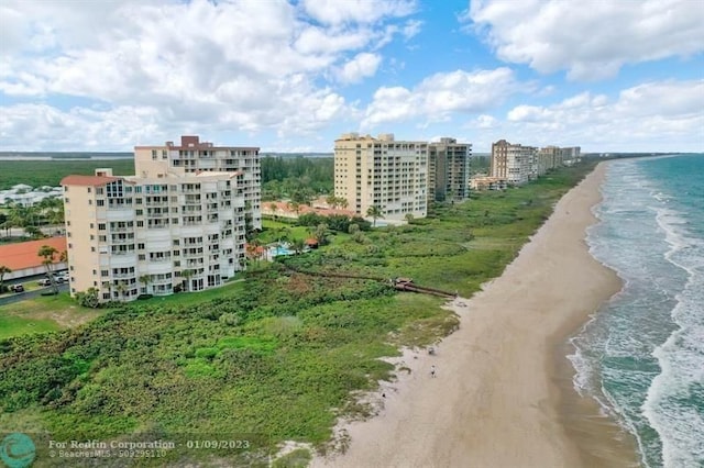 bird's eye view featuring a view of the beach and a water view