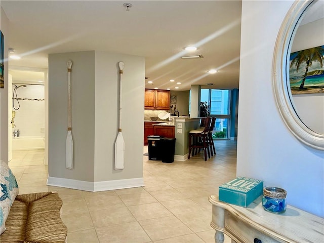 corridor featuring light tile patterned floors