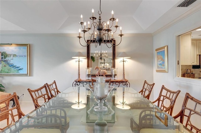 dining space with an inviting chandelier, ornamental molding, and a raised ceiling