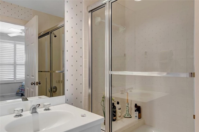 bathroom featuring walk in shower, ceiling fan, and vanity