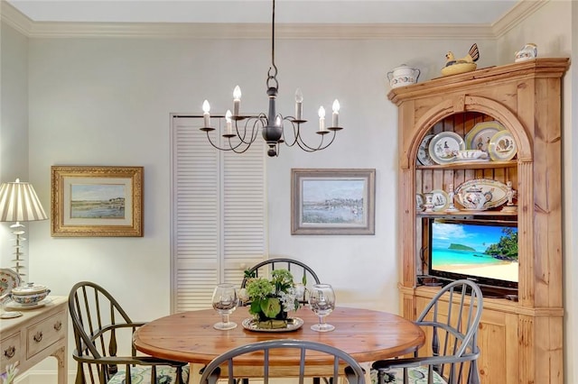 dining area featuring ornamental molding and a chandelier