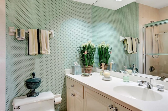 bathroom with vanity, an enclosed shower, and toilet