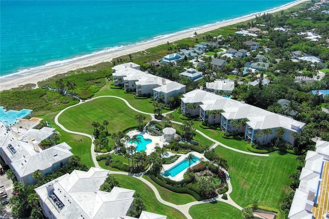 drone / aerial view featuring a view of the beach and a water view