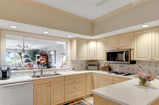 kitchen with tasteful backsplash, crown molding, sink, and white appliances