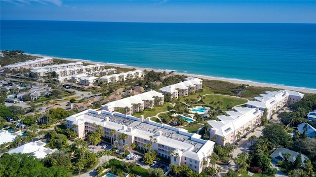 birds eye view of property featuring a view of the beach and a water view