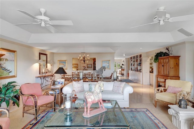 carpeted living room featuring a raised ceiling and ceiling fan with notable chandelier