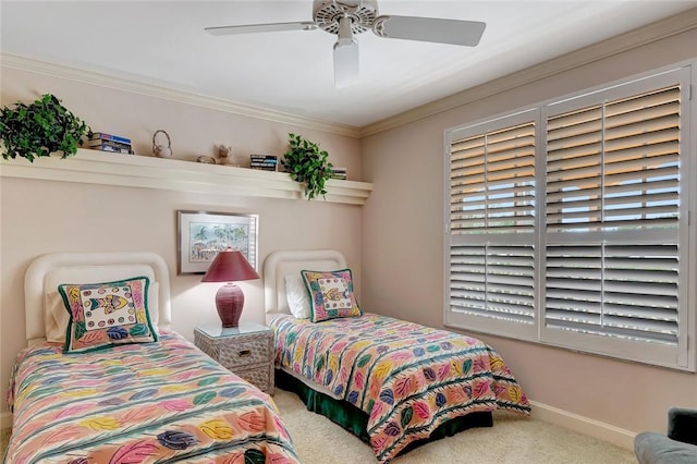 carpeted bedroom with ceiling fan and ornamental molding