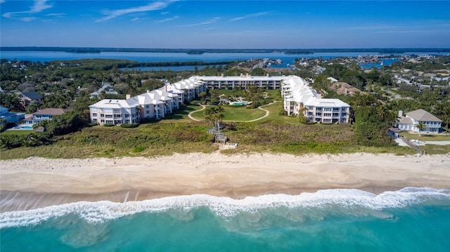 birds eye view of property featuring a water view and a beach view