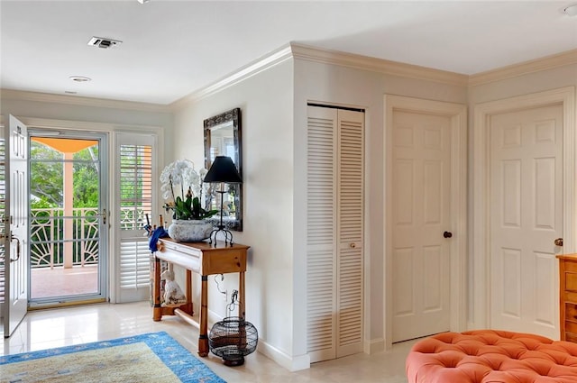 tiled entryway featuring ornamental molding