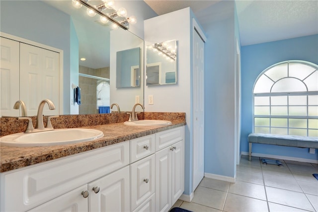 1158 Laconia St, Sebastian, FL 32958 - ensuite bathroom featuring tile patterned flooring, double vanity, a sink, and a stall shower