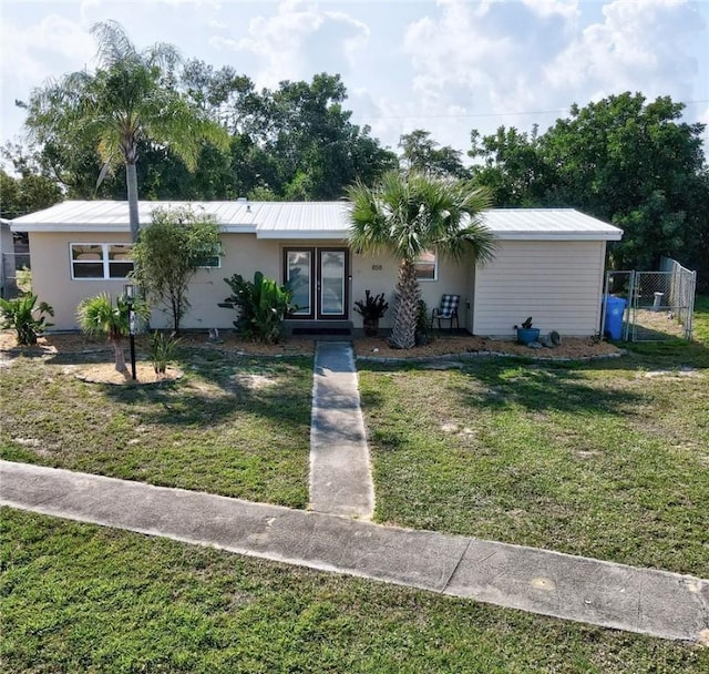 ranch-style home with a front lawn