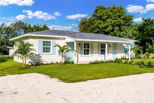 single story home featuring a front lawn