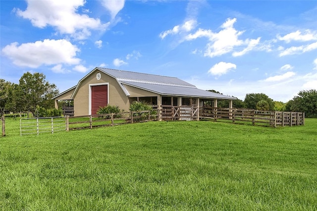 view of horse barn with a rural view